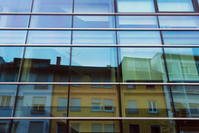 Reflection Of Old Buildings In New Building Glass