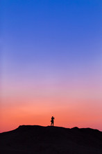 A Man On The Top Of Mountain In Sunset