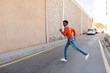 © BONNINSTUDIO/Stocksy - Portrait of a cool black man crossing the street.