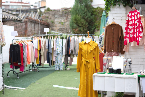 Yellow Second Hand Dress Is Put On Mannequin In Front Of The House