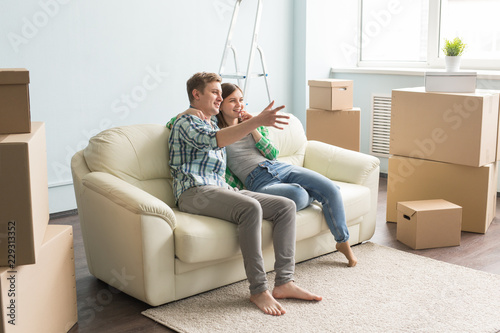 Furniture Moving And People Concept Happy Couple Sitting On New