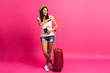 Leinwandbild Motiv Woman traveler with suitcase on color background.