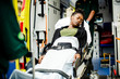 © Rawpixel.com - Paramedics moving a patient on a stretcher into an ambulance