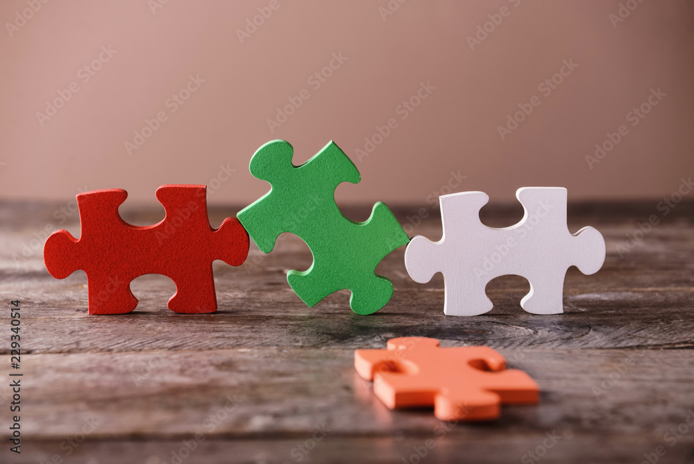 Colorful pieces of puzzle on wooden table