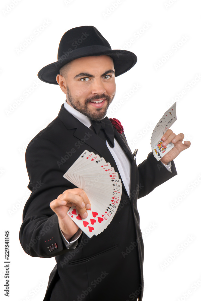 Male magician showing tricks with cards on white background