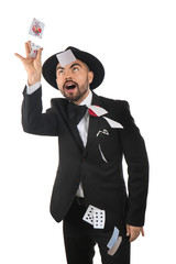 Wall Mural - Male magician showing tricks with cards on white background