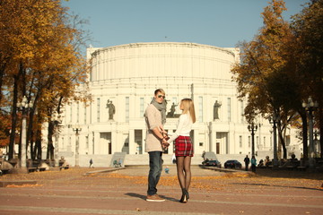 Wall Mural - couple people young man and women walking autumn park fanny sunny day