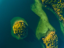 Top View Of A Small Green Island In The Blue Lake
