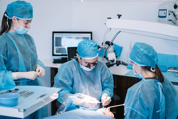 Dentist during a dental intervention with a patient. Dental clinic concept.