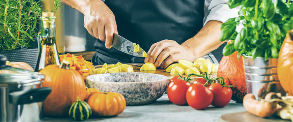 The chef slicing vegetables.