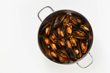 freshly cooked mussels in a frying pan in tomato sauce. pepata di cozze or mussels marinara. classic dish of mediterranean italian cuisine . isolated on white