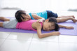 Leinwandbild Motiv Asian Chinese little sisters lying on yoga mat