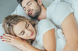 © LIGHTFIELD STUDIOS - close-up shot of beautiful young couple sleeping together in bed at home