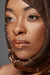 © LIGHTFIELD STUDIOS - portrait of pensive african american model with head wrap looking away isolated on grey