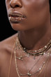 © LIGHTFIELD STUDIOS - cropped shot of african american woman with sparkling lip gloss isolated on black