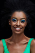 © LIGHTFIELD STUDIOS - portrait of smiling african american model with bright blue eyes shadows isolated on black