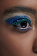 © LIGHTFIELD STUDIOS - partial view of african american woman with bright blue eye shadow