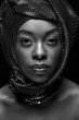 © LIGHTFIELD STUDIOS - black and white photo of stylish african american woman looking at camera isolated on black