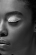 © LIGHTFIELD STUDIOS - black and white photo of african american woman with eye closed