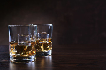 Wall Mural - Glasses with whiskey and ice cubes