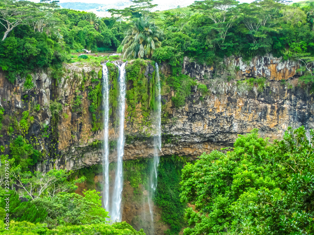 The Chamarel falls, 100 meters high, the most famous waterfalls in Mauritius at a short distance from the colored earth, Mauritius, Indian Ocean. - obrazy, fototapety, plakaty 