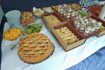 Coffee break at conference meeting. Business and entrepreneurship. The waitress filed a glass of white coffee with the sausage between the brake and the brake food background. yellow patterned cake