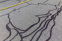 Asphalt Road With Filled Cracks. Background Of The Fixed Road