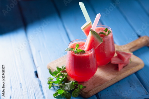 Fotografie, Obraz Tasty cold watermelon smoothie drink with mint in glasses, summer refreshing coc