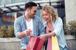 © ivanko80 - Young happy couple with shopping bags in the city