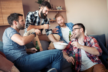 Happy male friends drinking beer