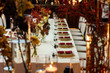 table setting in a restaurant decorated with napkins on plates and flowers and candles
