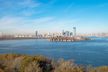 VIEW OF ELLIS ISLAND NATIONAL MUSEUM OF IMMIGRATION AND SKYSCRAPERS, VIEW FROM STATUE OF LIBERTY, NEW YORK, USA