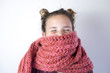 © Celeste - Young girl bundled with pink knitted scarf.