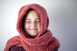 © Celeste - Young girl bundled with pink knitted scarf.