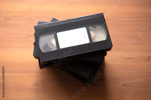 Fotomural Stacked VHS vcr video cassette tape with white blank label.