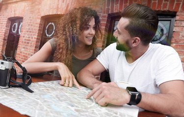 Poster - Couple in an outdoor cafe using map and planning itinerary