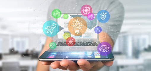 Poster - Businessman holding a Cloud of colorfull start up icon bubble with a laptop 3d rendering