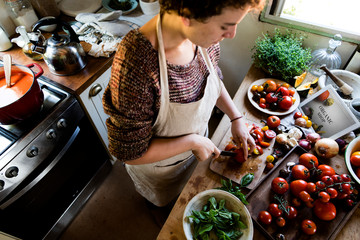 Woman slicing tomatoes for pasta sauce