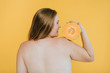 Strong blond woman holding a cantaloupe melon