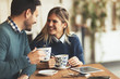 © NDABCREATIVITY - Happy young couple on date in coffee shop