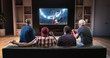 © haizon - Group of fans are watching a soccer moment on the TV and celebrating a goal, sitting on the couch in the living room.