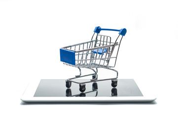 E-commerce concept: empty shopping cart on digital tablet isolated