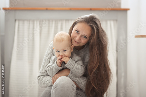 Fotografie, Obraz Happy mother and baby hugging, closeup portrait