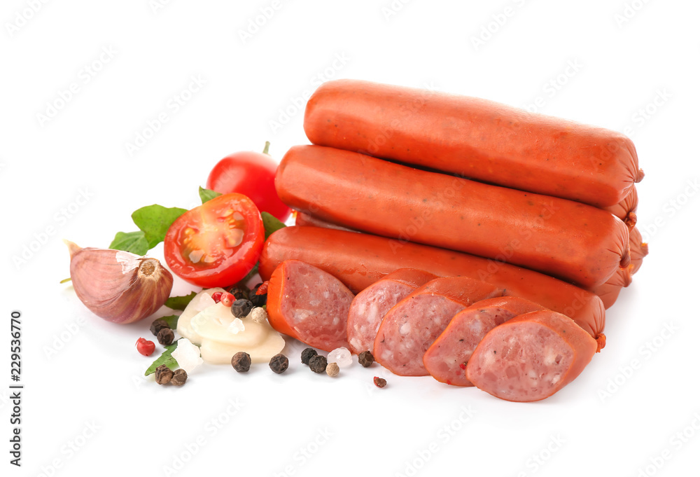 Delicious sausages with tomatoes and spices on white background