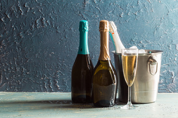 Wall Mural - Champagne bottle in bucket with ice and glasses of champagne