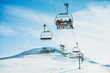 People on ski lift in winter ski resort
