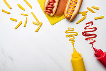 Top View Of Hot Dogs With Mustard And Ketchup On White Marble Surface