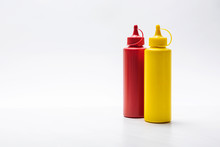 Close-up Shot Of Bottles Of Ketchup And Mustard On White Surface
