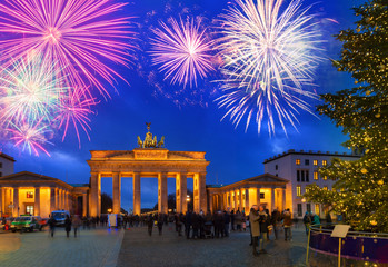 Bradenburg Gate with Christmas tree at night with fireworks, Berlin Germany