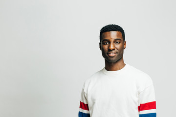 Portrait of a casual young man looking at the camera, isolated on white studio background